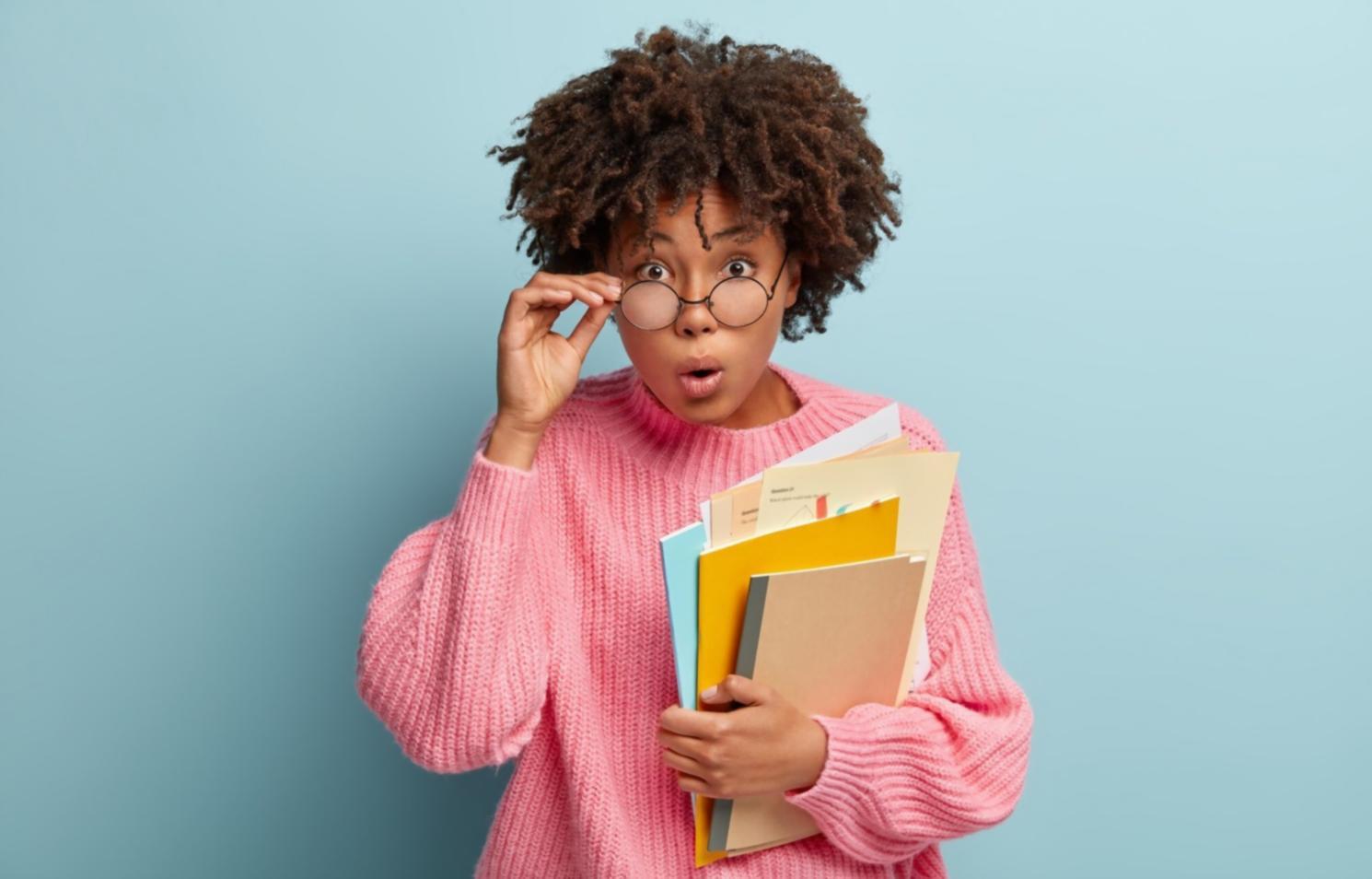 Financial planning documents and calculator on desk showing real budget analysis